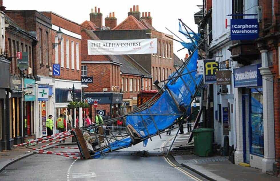 Refuse truck brings down scaffolding on busy street