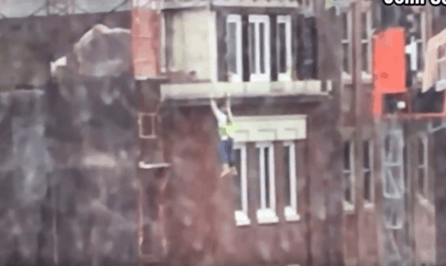 Scaffolding collapse leaves worker hanging off building and pedestrian critically injured