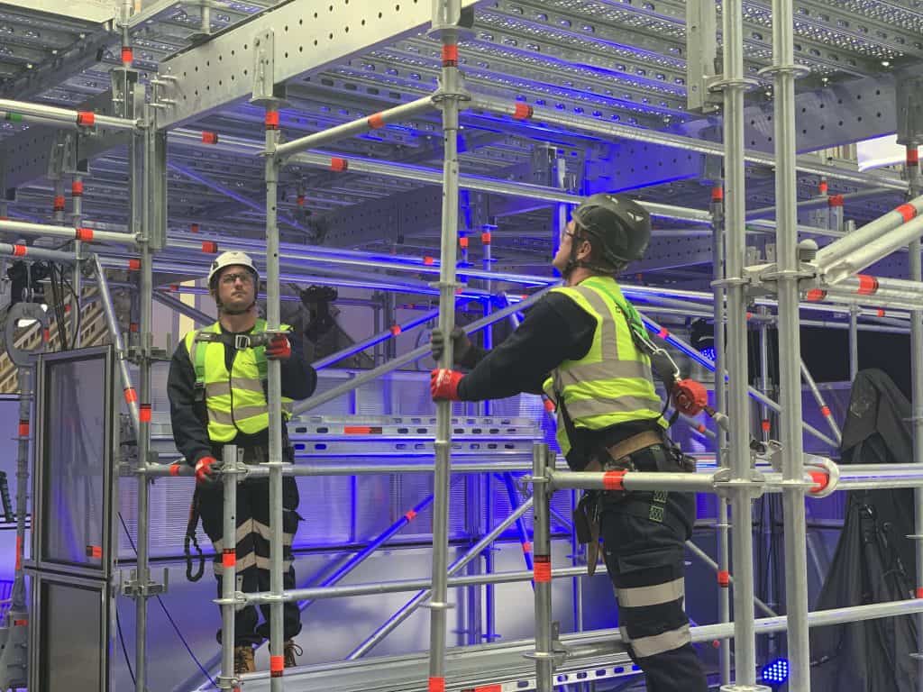 Image shows scaffolders demonstrating the benefits of the new Layher Aluminium FlexBeam  