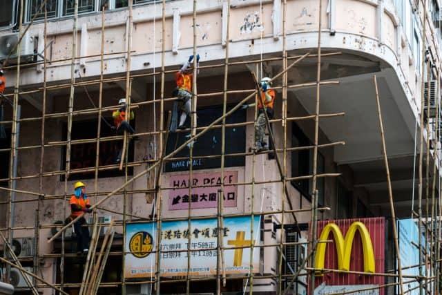 scaffolders erecting bamboo scaffolding in Hong Kong