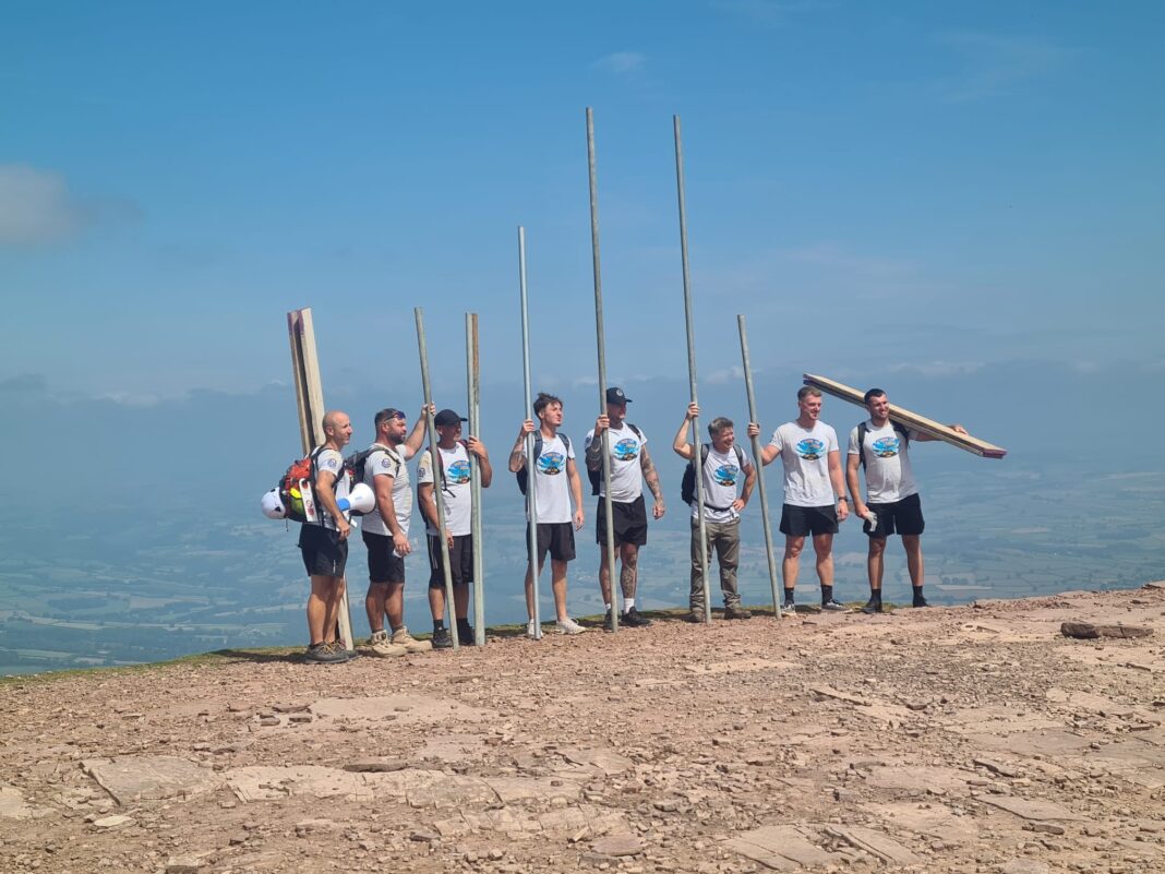 A group of scaffolders have carried and erected an eight-metre-high tower on the summit of Pen y Fan in Wales in support of a Bristol colleague with terminal cancer.