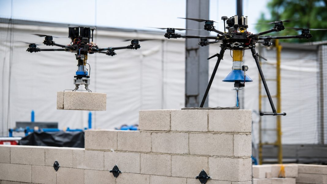 Researchers have demonstrated a two-drone system that can place bricks and apply adhesive autonomously, highlighting future potential for aerial construction robotics.